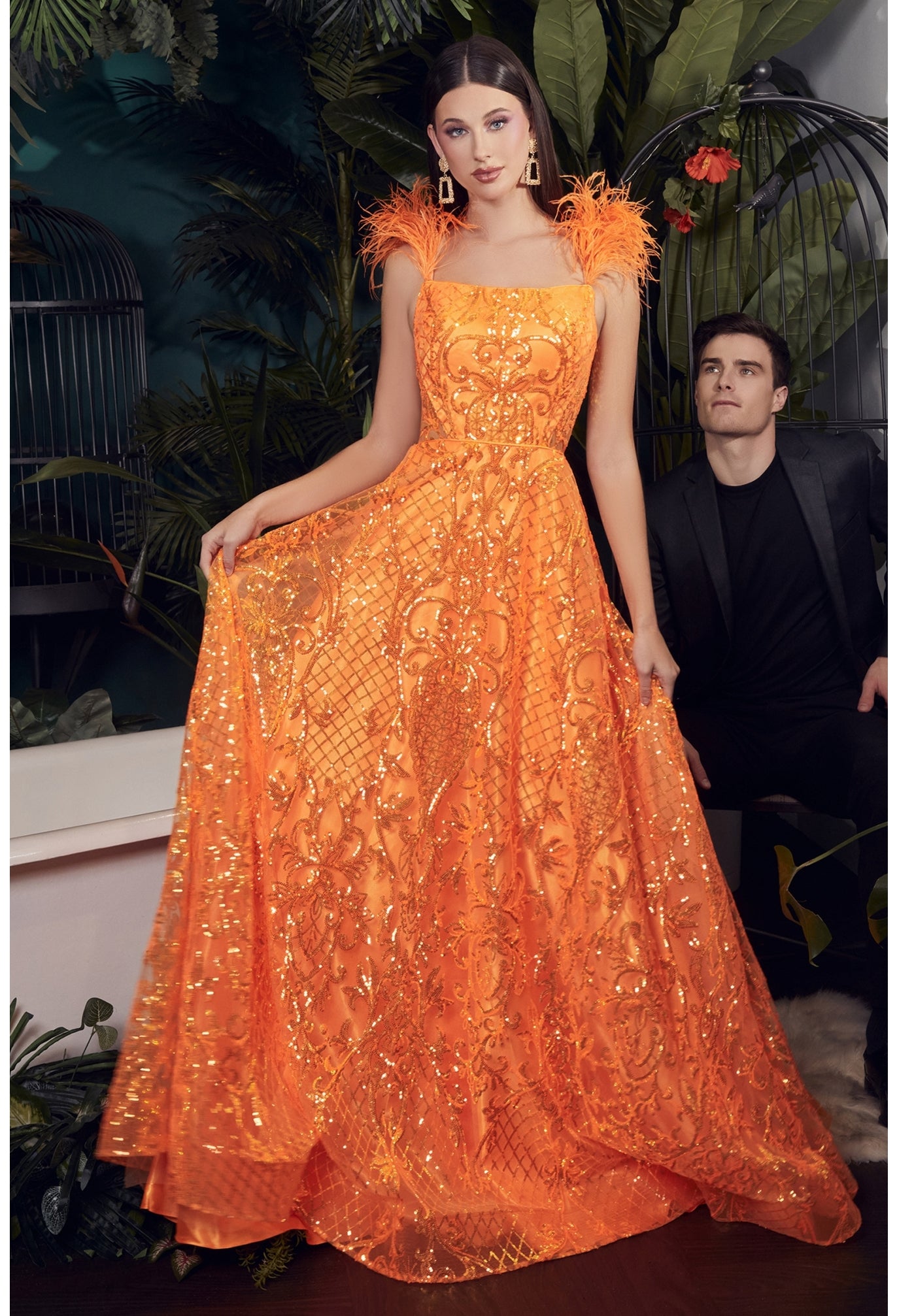 Ladivine KV1076 Neon Orange Sequin Feather Prom Dress A Line Sheer Backless Formal Gown Make a bold, statement in this stunning neon orange ball gown! Not for the faint of heart, this gown is sure to draw attention at any formal event. The faux feather straps scream glamour while providing ample support, while the shimmery sequin scroll and lattice design will glisten underneath any lights. 