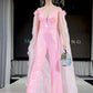 Marc Defang 8099 This is a long pageant formal wear jumpsuit that is made of sequins and has off the shoulder straps.  The straps are attached to a cape with feathers at the shoulders.  Wow the crowd at your next pageant. hot pink