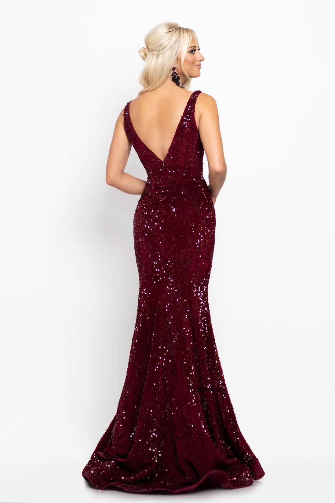 Johnathan Kayne 2237 This long prom dress has a plunging v neckline with mesh panel and a mid v back and is made of luxurious stretch velvet scattered with sequins.  The long mermaid skirt on this pageant gown has a sweeping train. Colors  Crimson, Emerald  Sizes  00, 0, 2, 4, 6, 8, 10, 12, 14, 16, 18, 20, 22