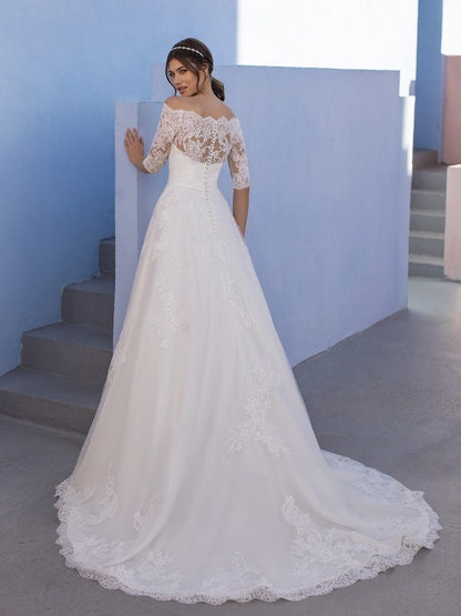 White One OSSA by Pronovias is Probably the wedding dress most little girls have dreamed of; this classic lace tulle gown has the sweetest of necklines with a lace yoke, pretty, lacey school-girl sleeves and a full-blown skirt with a scalloped edge. A Line Lace Ballgown with off the shoulder eyelash three quarter length sheer sleeves. Embroidered Lace Stunning Plus Size Bridal Gown!  Available Size: 28  Available Color: Off White
