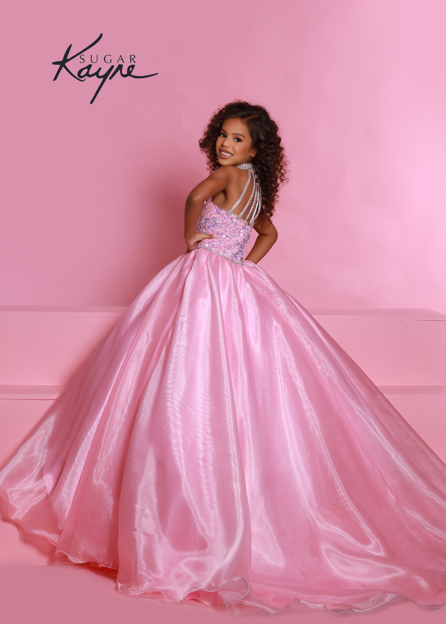 Sugar Kayne C302 sequin stretch velvet and organza ballgown features a stunning beaded halter with dropped waist and rhinestone trim and beaded strap back  Available Sizes: 2-16  Available colors: Aqua, Cotton candy, Orchid, Powder Blue