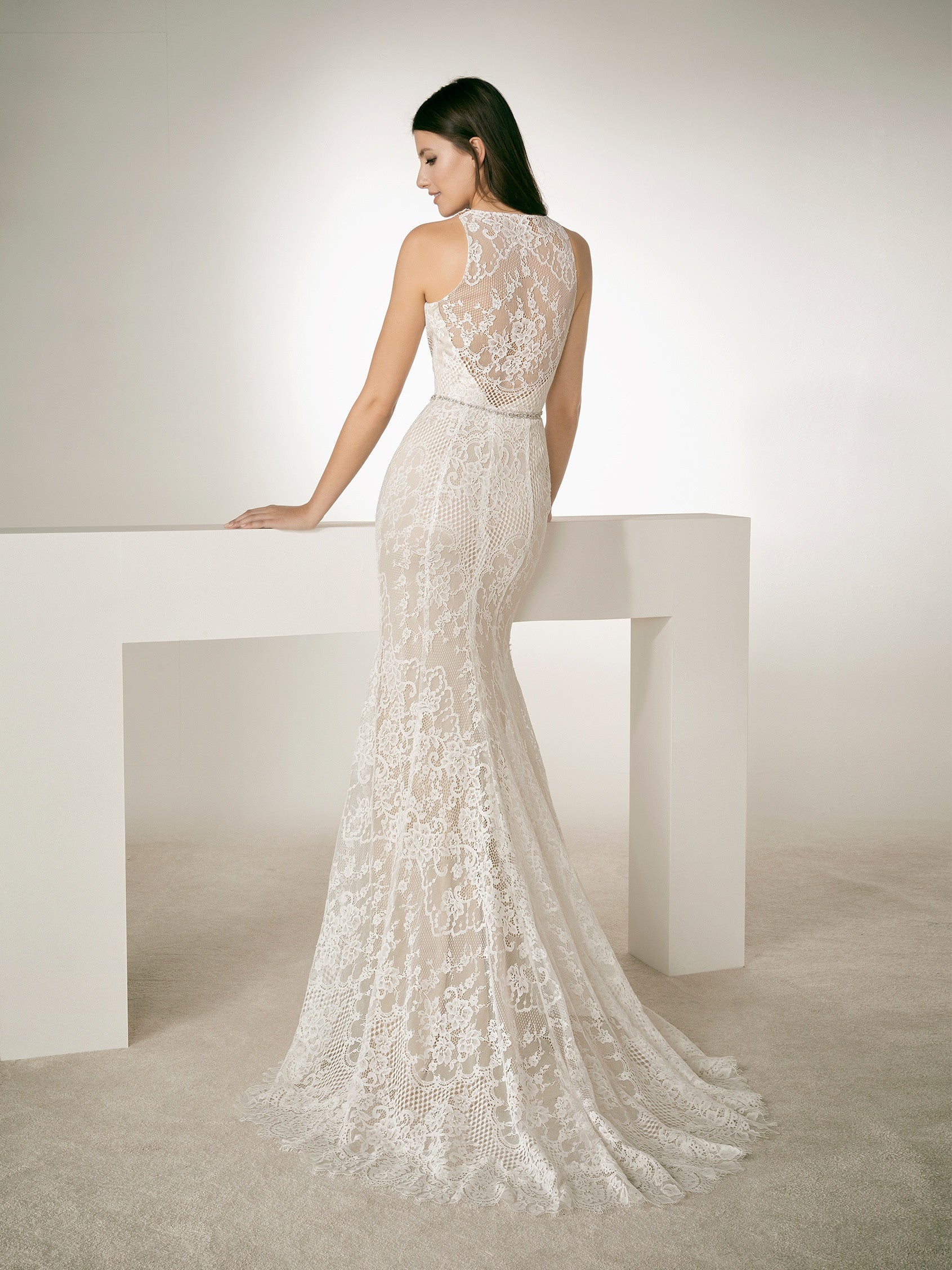 White One Bridal RAF is a stunning Lace Wedding Gown Featuring a Long Fitted Mermaid Silhouette with a Sheer Lace illusion high halter neckline. This sheer Back bridal gown features a crystal waist belt. and sweeping train.  IN STOCK FOR IMMEDIATE DELIVERY   US SIZE 8 -OFF WHITE/LIGHT BEIGE