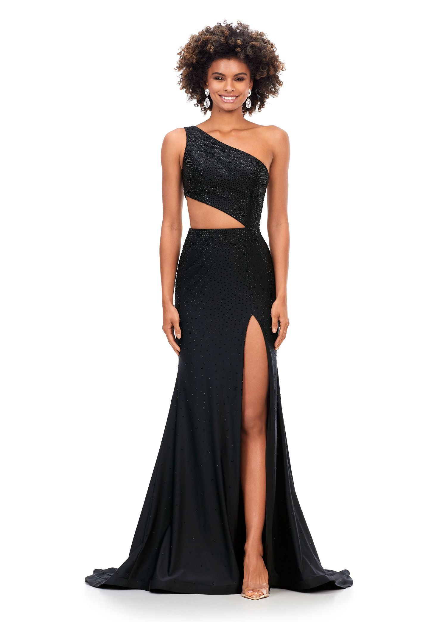 Ashley Lauren 11337 Stand out in this fitted one shoulder jersey gown embellished with heat set stones. The look is complete with an asymmetrical sharkbite cut out and left leg slit. One Shoulder Cut Out Heat Set Stones Jersey COLORS: Hot Pink, Turquoise, Black, Red, Violet