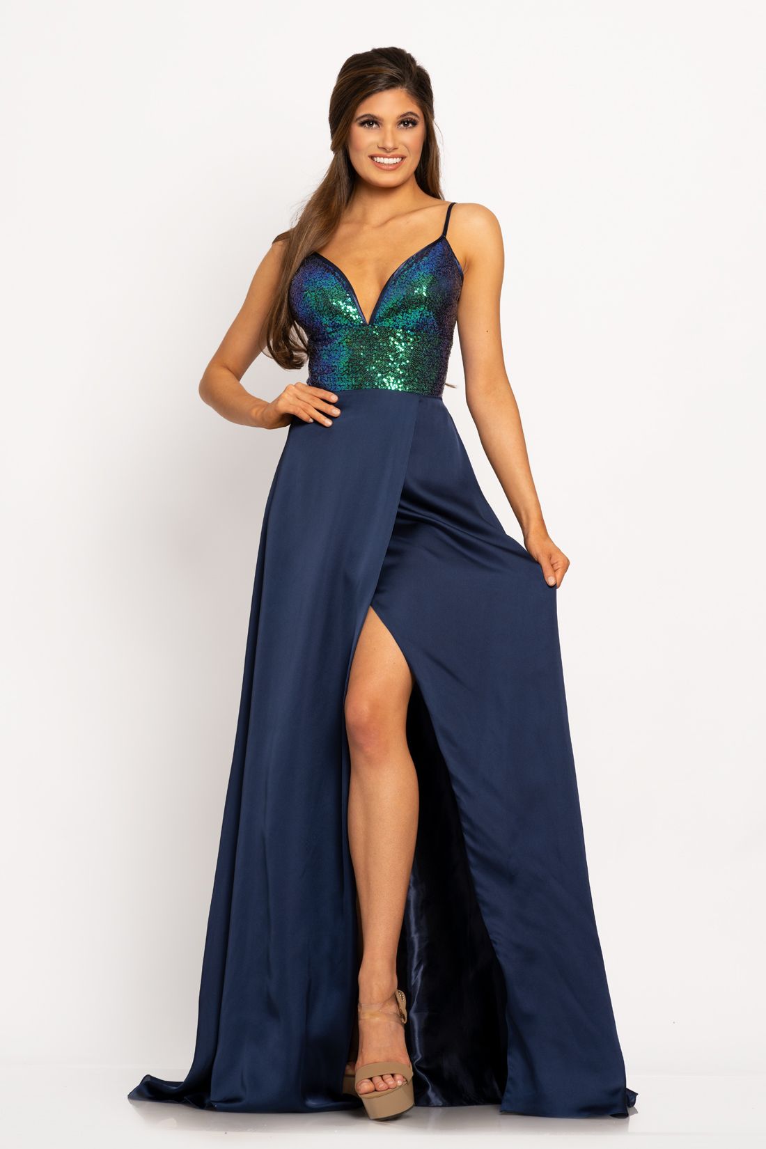 Johnathan Kayne 2214 Sequin bodice with a V neckline trimmed with charmeuse and spaghetti straps A line prom dress. The long charmeuse skirt on this pageant dress features a wrap style slit.   Colors Berry, Navy, Teal  Sizes  00, 0, 2, 4, 6, 8, 10, 12, 14, 16 
