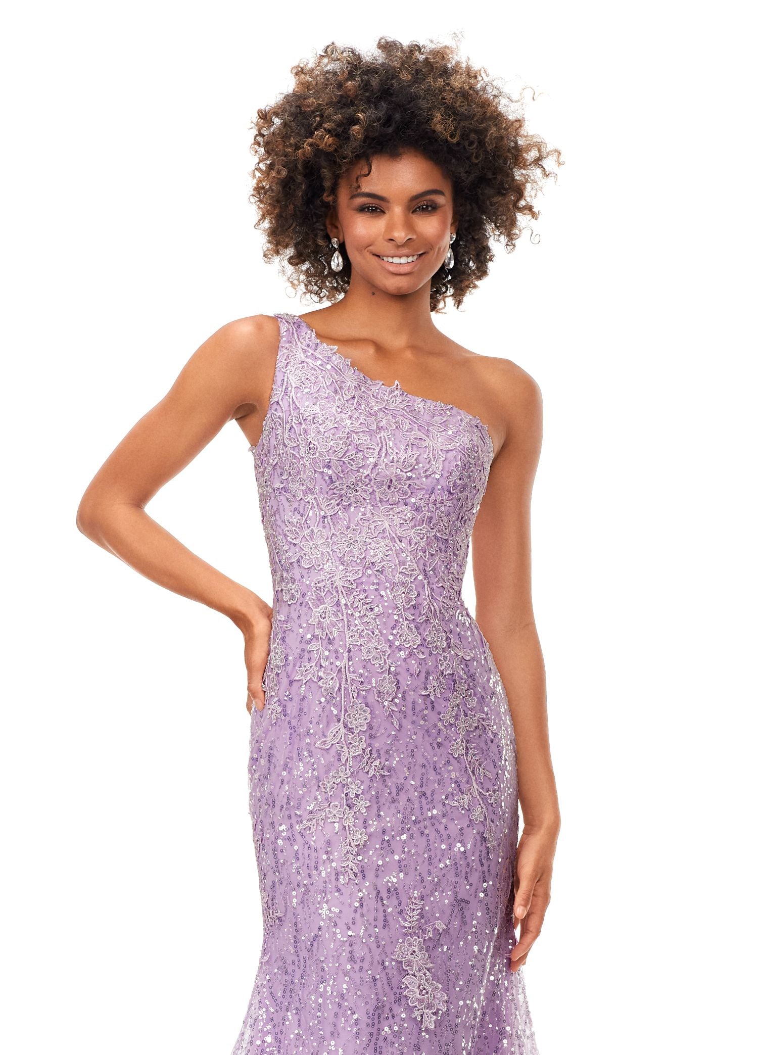 Ashley Lauren 11334 Feel ultra glamourous in this one shouldersequin gown. The bodice is embellished with lace appliques that cascade down onto the fitted skirt. The look is complete with a full zipper back. One Shoulder Fitted Skirt Sequin Applique Sweep Train COLORS: Sky, Lilac