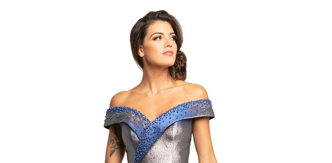 Johnathan Kayne 2072 is an off the shoulder Prom Dress, Pageant Gown & Formal Evening Wear. Featuring a Metallic Shimmer Brocade Material. This Ballgown has a full Pleated skirt, Fitted Off the Shoulder Bodice with pearl embellishments. 