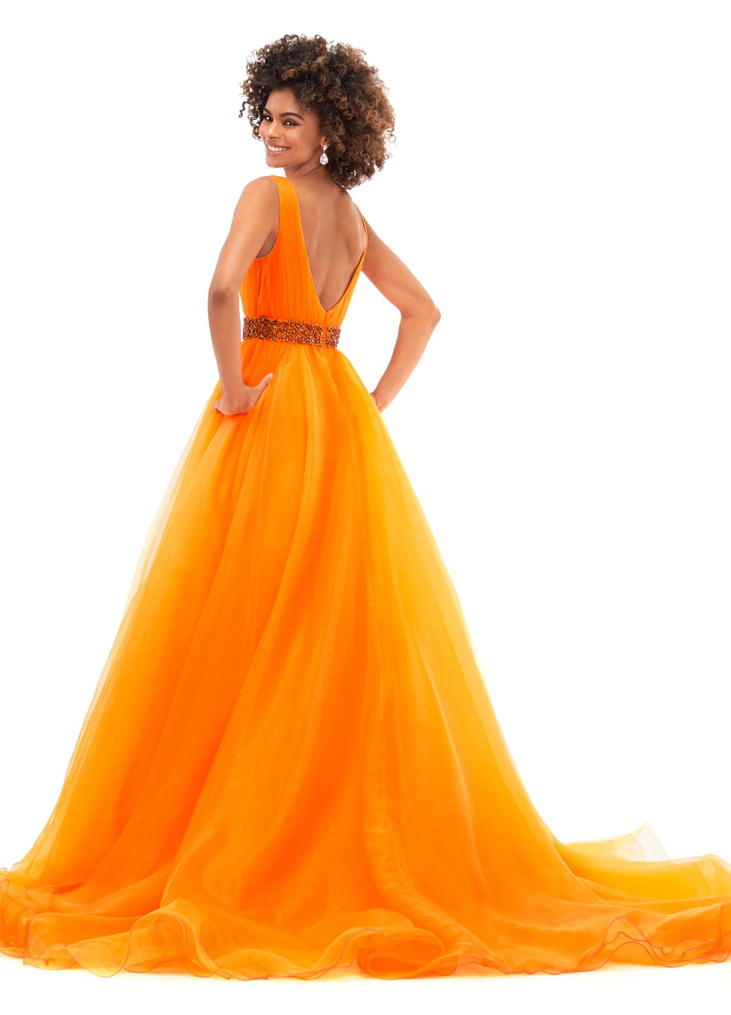 Ashley Lauren 11305 Stand out in this ball gown complete with a crystal encrusted waistband. The bustier has a deep v-neckline and a v-back. The gown is finished with a long, lavish train. V-Neckline V-Back Crystal Belt Organza COLORS: Orange, Royal, Red