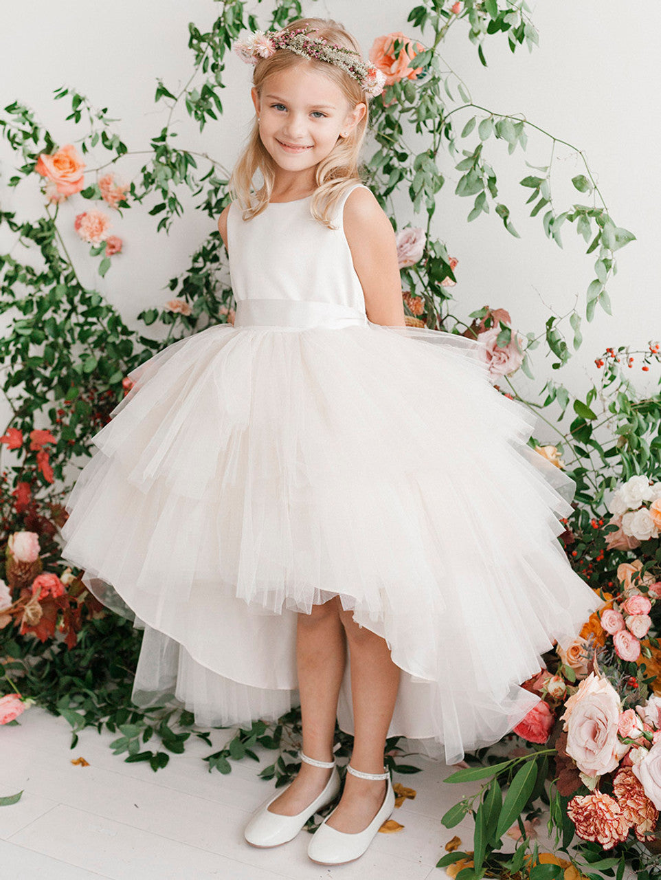 This Tip Top 5658 Girls Layered Tulle High Low Skirt Formal Dress is a perfect choice for that special day. The tulle high-low skirt, satin formal gown, and flower girl satin sash come together to create a beautiful, unique look perfect for flower girls, junior bridesmaids or formal occasions.  Sizes: 6M-16  Colors: Black, Blush, Burgundy, Eggplant, Ivory, Red, Royal Blue, White, Champagne, Lilac, Sky Blue