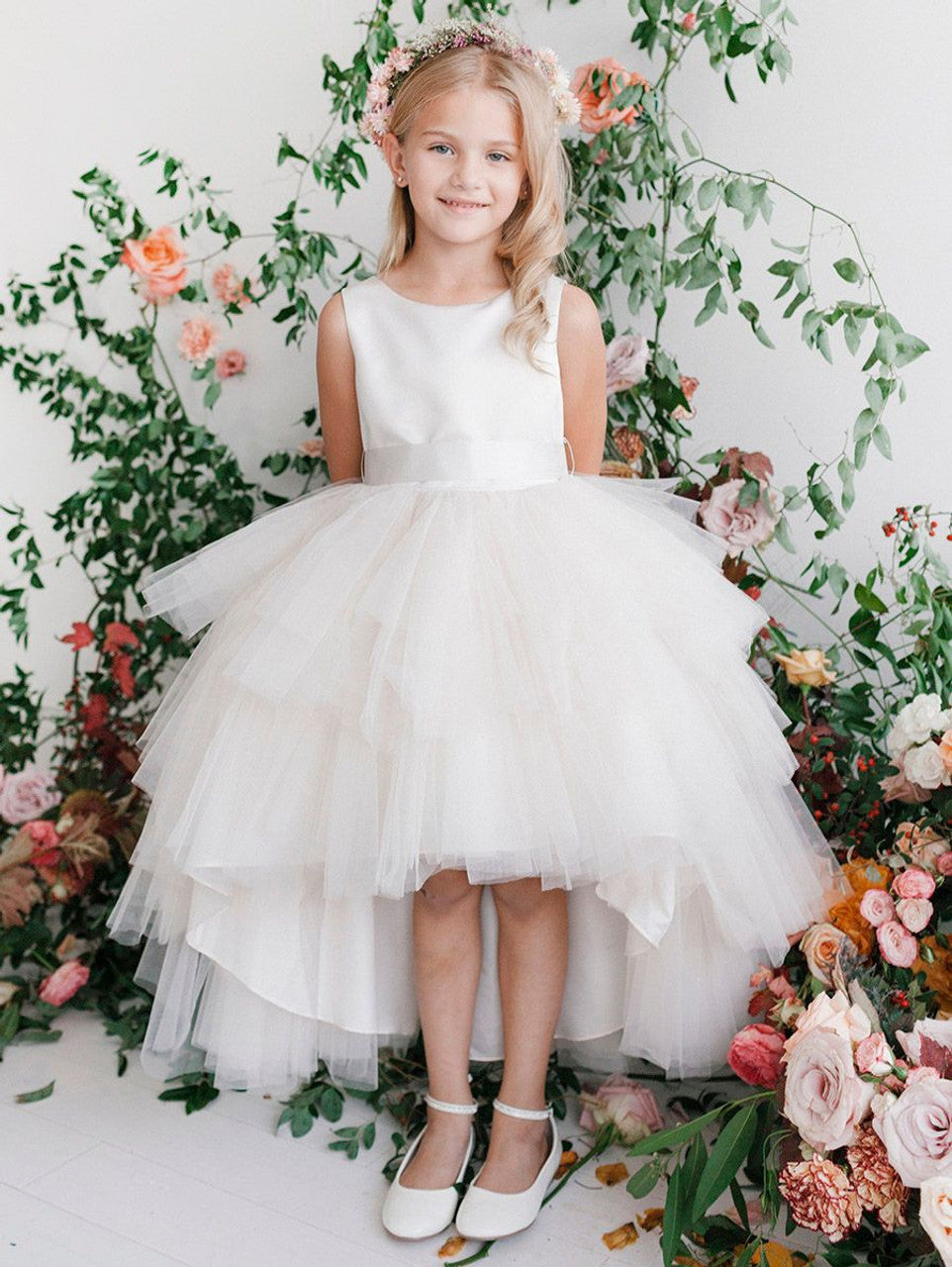 This Tip Top 5658 Girls Layered Tulle High Low Skirt Formal Dress is a perfect choice for that special day. The tulle high-low skirt, satin formal gown, and flower girl satin sash come together to create a beautiful, unique look perfect for flower girls, junior bridesmaids or formal occasions.  Sizes: 6M-16  Colors: Black, Blush, Burgundy, Eggplant, Ivory, Red, Royal Blue, White, Champagne, Lilac, Sky Blue